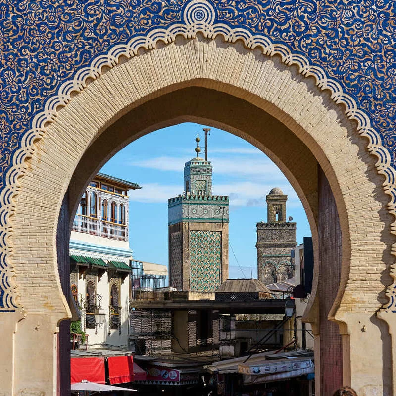 a square minaret seen through bab bou jeloud gate in fes morocco 17040328314882047555107